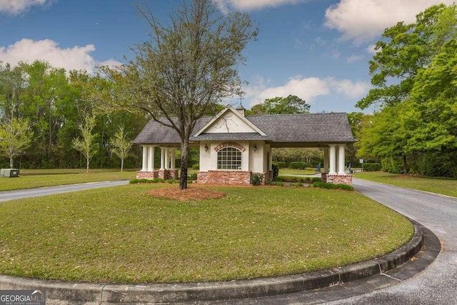 surrounding community featuring driveway, a yard, and an attached carport