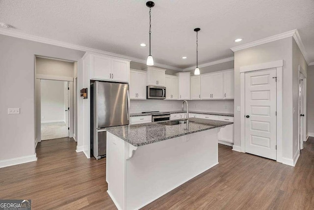 kitchen with stainless steel appliances, white cabinets, a sink, and dark wood-type flooring