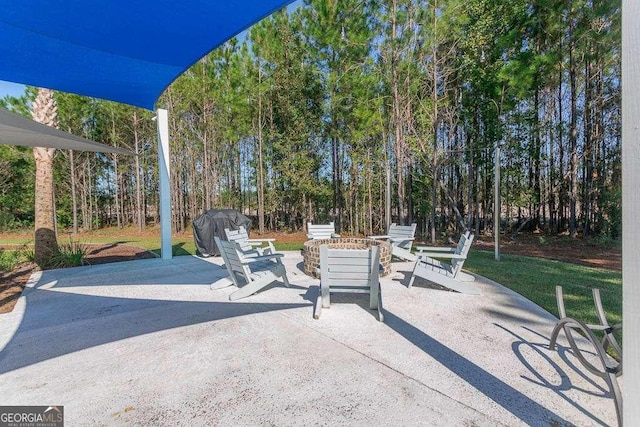 view of patio / terrace with an outdoor fire pit and a grill