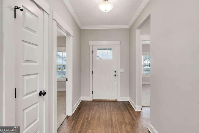 entryway with baseboards, dark wood-style flooring, a wealth of natural light, and crown molding