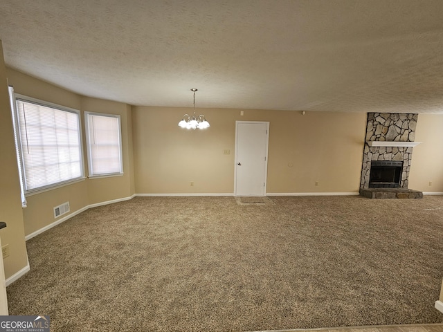 unfurnished living room featuring a textured ceiling, carpet floors, and a fireplace