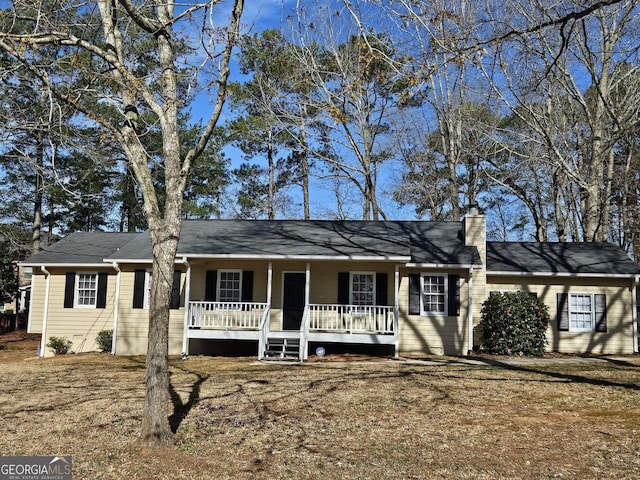 ranch-style house with covered porch and a chimney