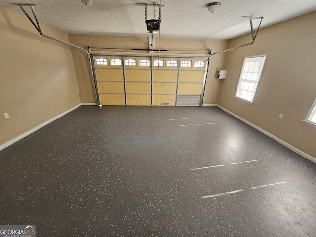 garage with baseboards and a garage door opener