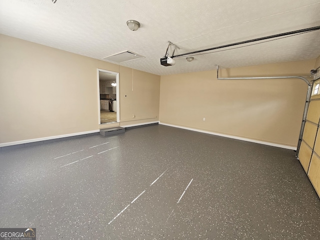 garage with baseboards and a garage door opener