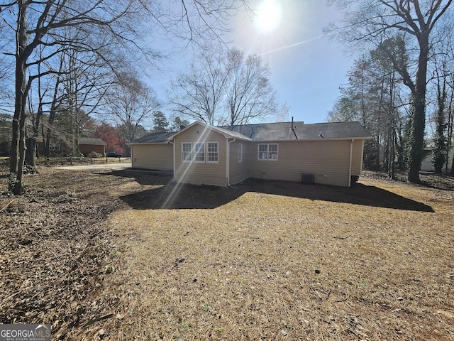 back of house with central AC unit