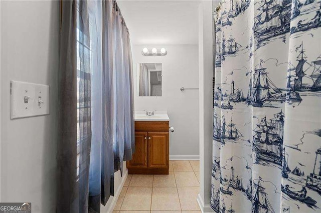 bathroom with tile patterned flooring, vanity, and baseboards