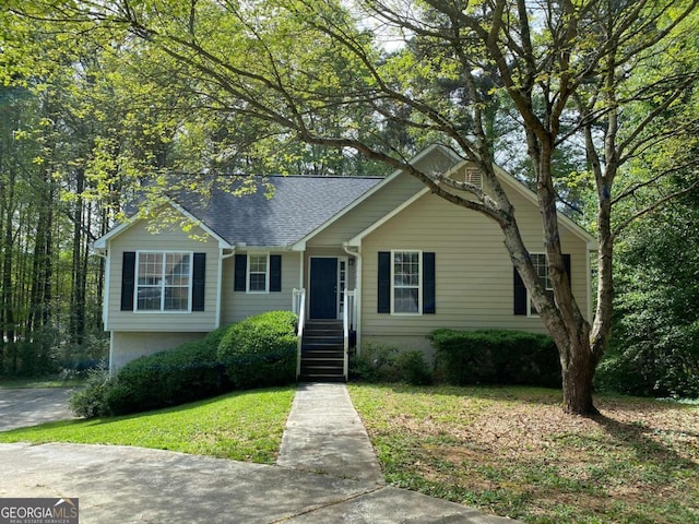 view of front of property with a front yard and roof with shingles