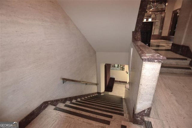 staircase featuring a fireplace