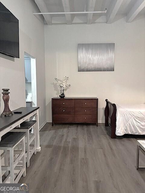 32 Peachtree St Unit 202, Atlanta, GA 30303 - bedroom featuring beamed ceiling, wood finished floors, and baseboards