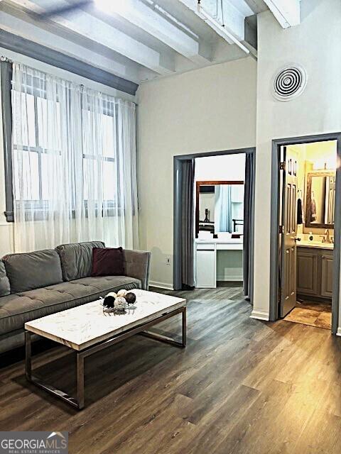 32 Peachtree St Unit 202, Atlanta, GA 30303 - living area featuring beam ceiling, wood finished floors, and baseboards