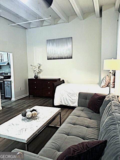 32 Peachtree St Unit 202, Atlanta, GA 30303 - bedroom with beam ceiling, dark wood-style flooring, and baseboards