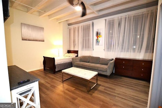 living room featuring beamed ceiling and wood finished floors