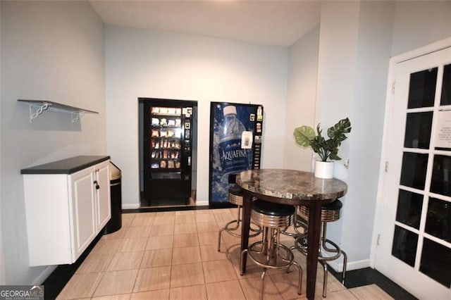 32 Peachtree St Unit 202, Atlanta, GA 30303 - dining room with baseboards, light tile patterned floors, and bar