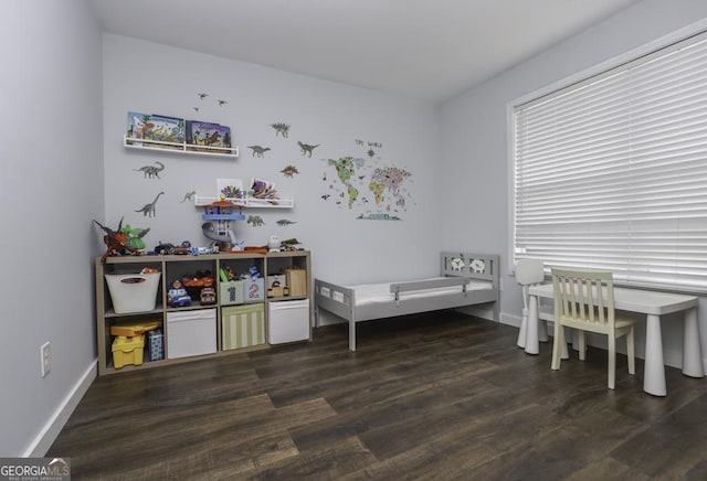 interior space with baseboards and wood finished floors