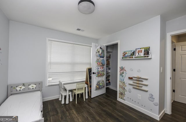 interior space with visible vents, baseboards, and wood finished floors