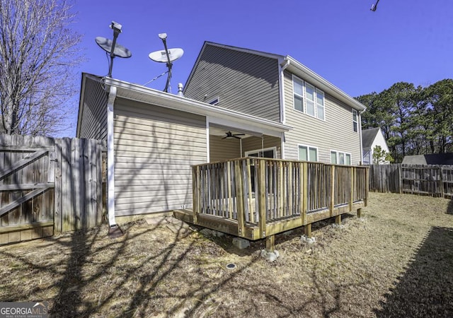 back of house with a fenced backyard, a deck, and a ceiling fan