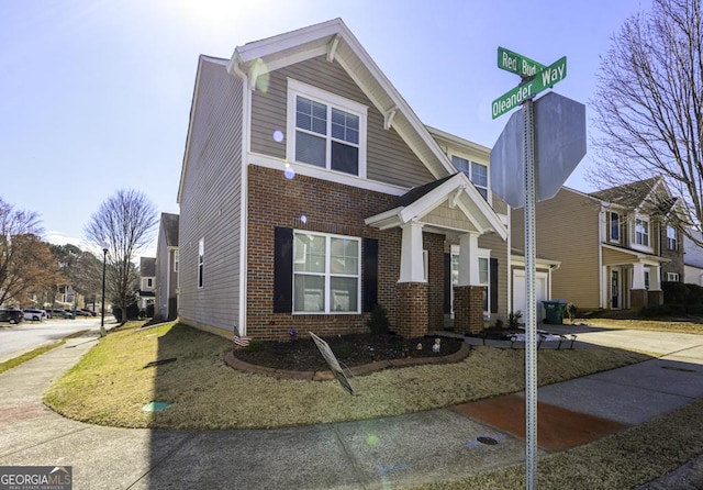 view of front of property featuring concrete driveway, brick siding, and an attached garage