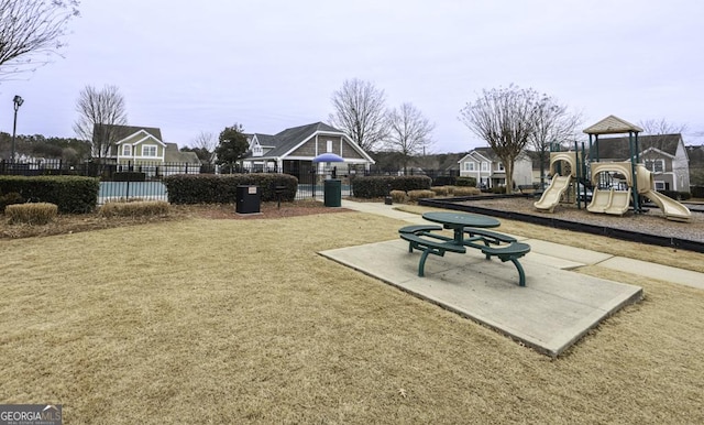 exterior space featuring a lawn and fence