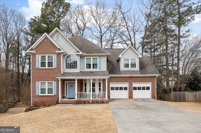 view of front of property featuring a porch, fence, concrete driveway, a garage, and brick siding