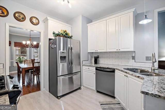 kitchen with white cabinetry, appliances with stainless steel finishes, and a sink