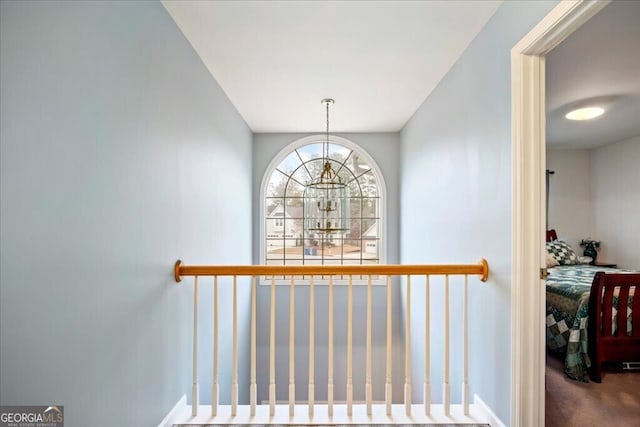 stairway featuring a chandelier and carpet flooring