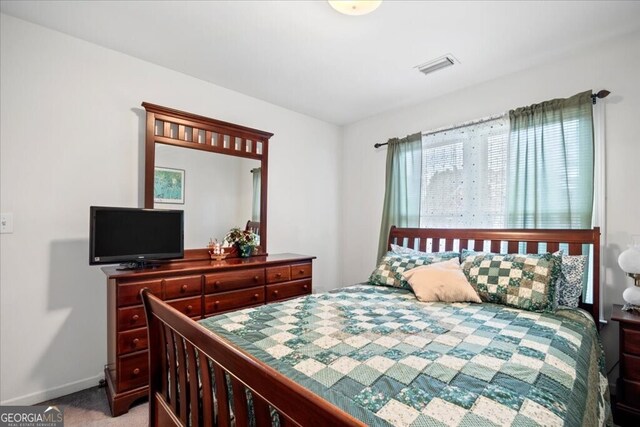 bedroom featuring visible vents, baseboards, and carpet floors