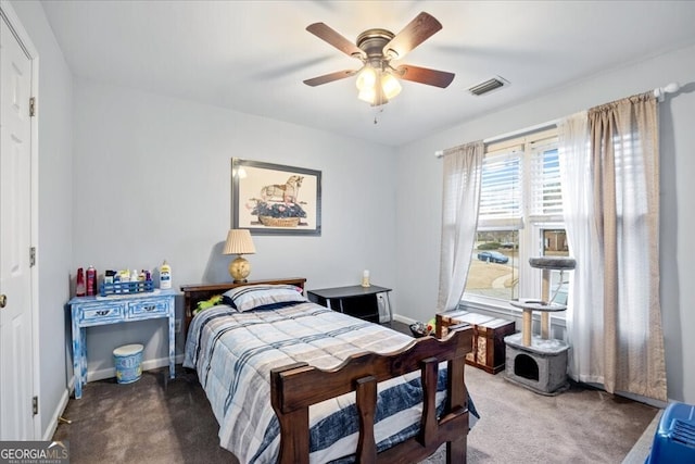 carpeted bedroom featuring visible vents, baseboards, and ceiling fan