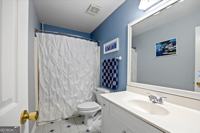 bathroom featuring vanity, a shower with curtain, visible vents, tile patterned flooring, and toilet