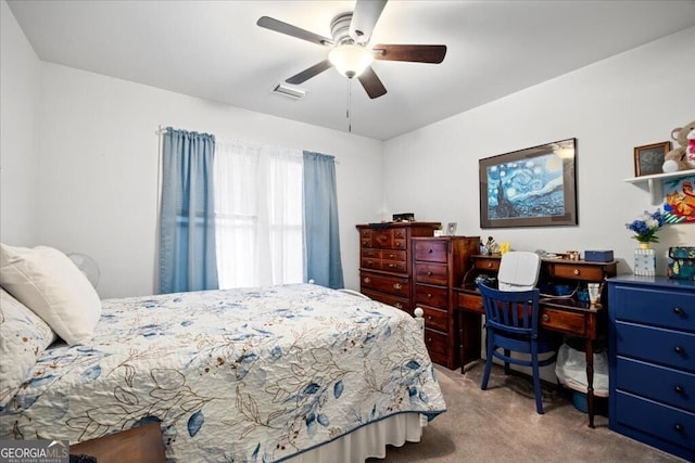 carpeted bedroom featuring visible vents and a ceiling fan