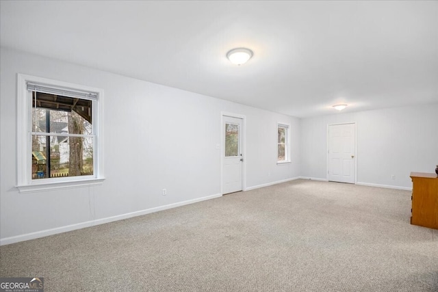 unfurnished room featuring baseboards and carpet floors