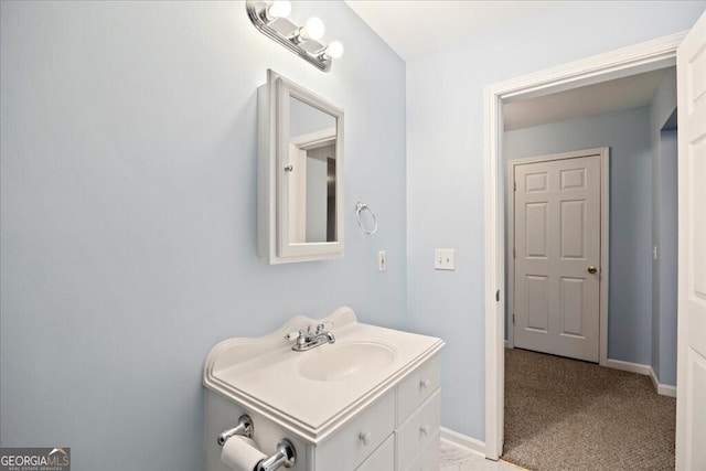 bathroom featuring baseboards and vanity