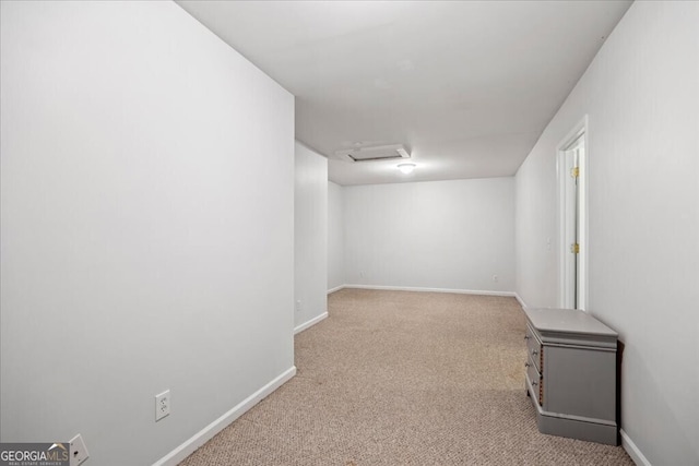 below grade area featuring baseboards and carpet