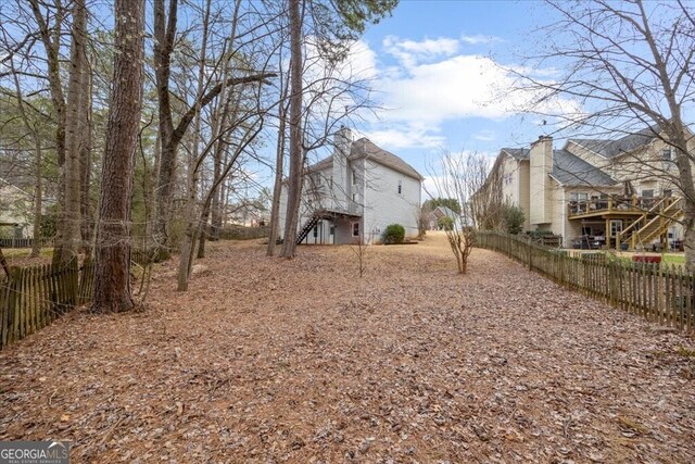 view of yard with stairs and fence