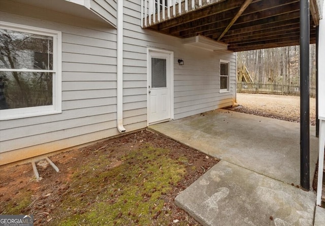 entrance to property with a patio and fence