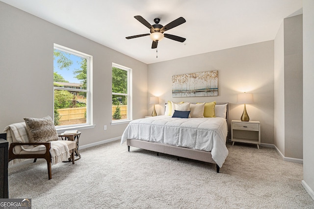 carpeted bedroom with a ceiling fan and baseboards