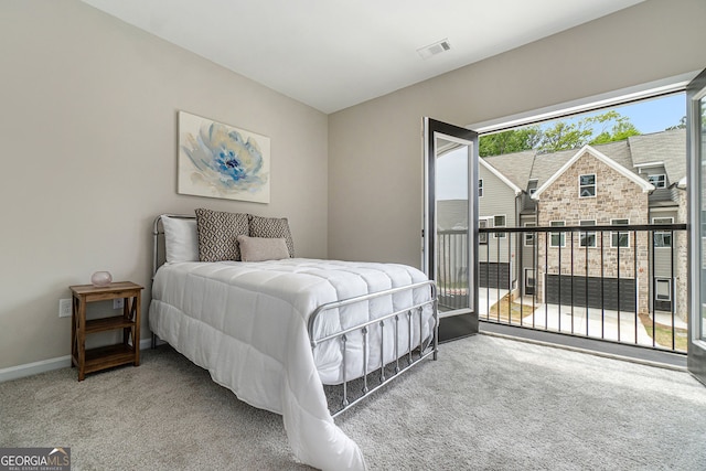 bedroom with access to exterior, carpet, visible vents, and baseboards