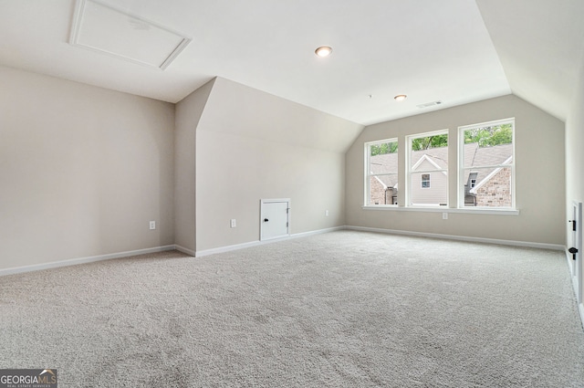 bonus room featuring lofted ceiling, carpet, visible vents, and baseboards