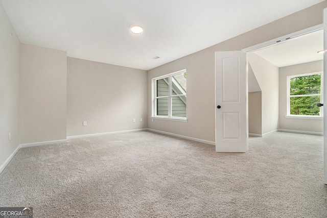 interior space with light carpet and baseboards