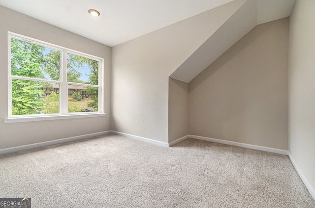 bonus room with carpet floors, lofted ceiling, and baseboards