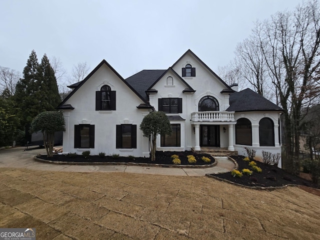 french country style house featuring stucco siding