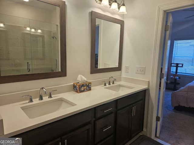 ensuite bathroom with double vanity, ensuite bath, a sink, and a shower stall