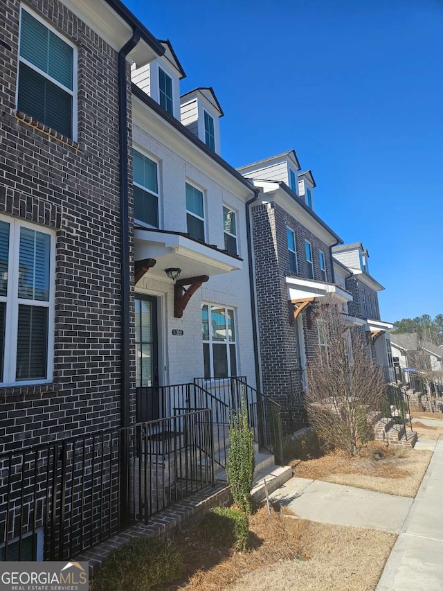 view of front facade featuring brick siding and a residential view