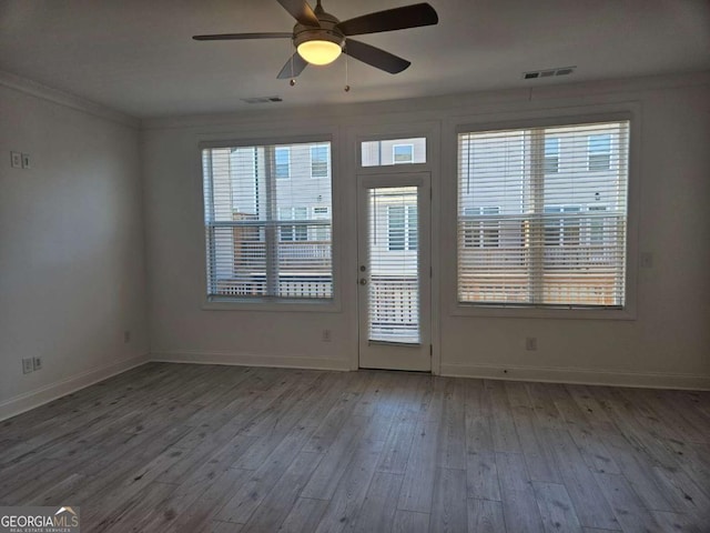 interior space featuring wood finished floors, visible vents, and baseboards