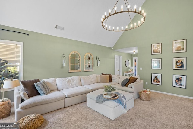 living area with visible vents, baseboards, carpet flooring, an inviting chandelier, and high vaulted ceiling