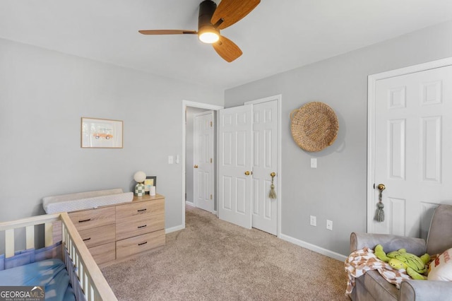 carpeted bedroom featuring baseboards and ceiling fan