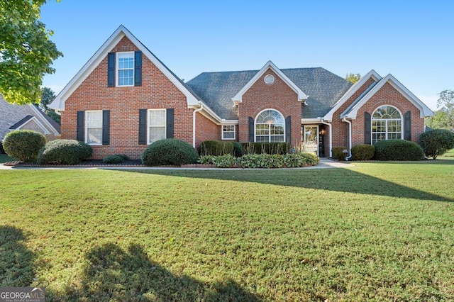 traditional home with brick siding, roof with shingles, and a front lawn