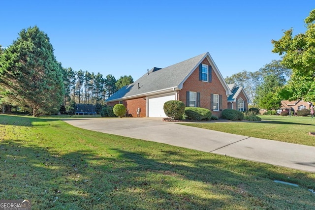 view of home's exterior featuring a yard, concrete driveway, a garage, a trampoline, and brick siding