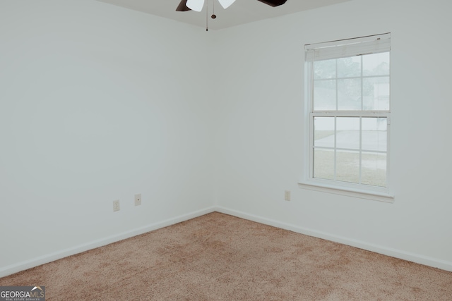 carpeted empty room with baseboards and ceiling fan