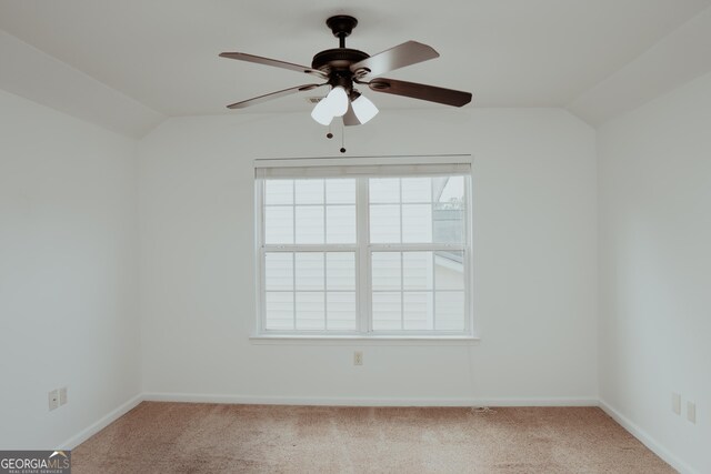 unfurnished room featuring baseboards, carpet, a ceiling fan, and vaulted ceiling
