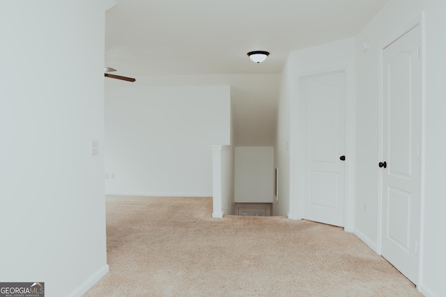 additional living space with baseboards, a ceiling fan, and carpet flooring